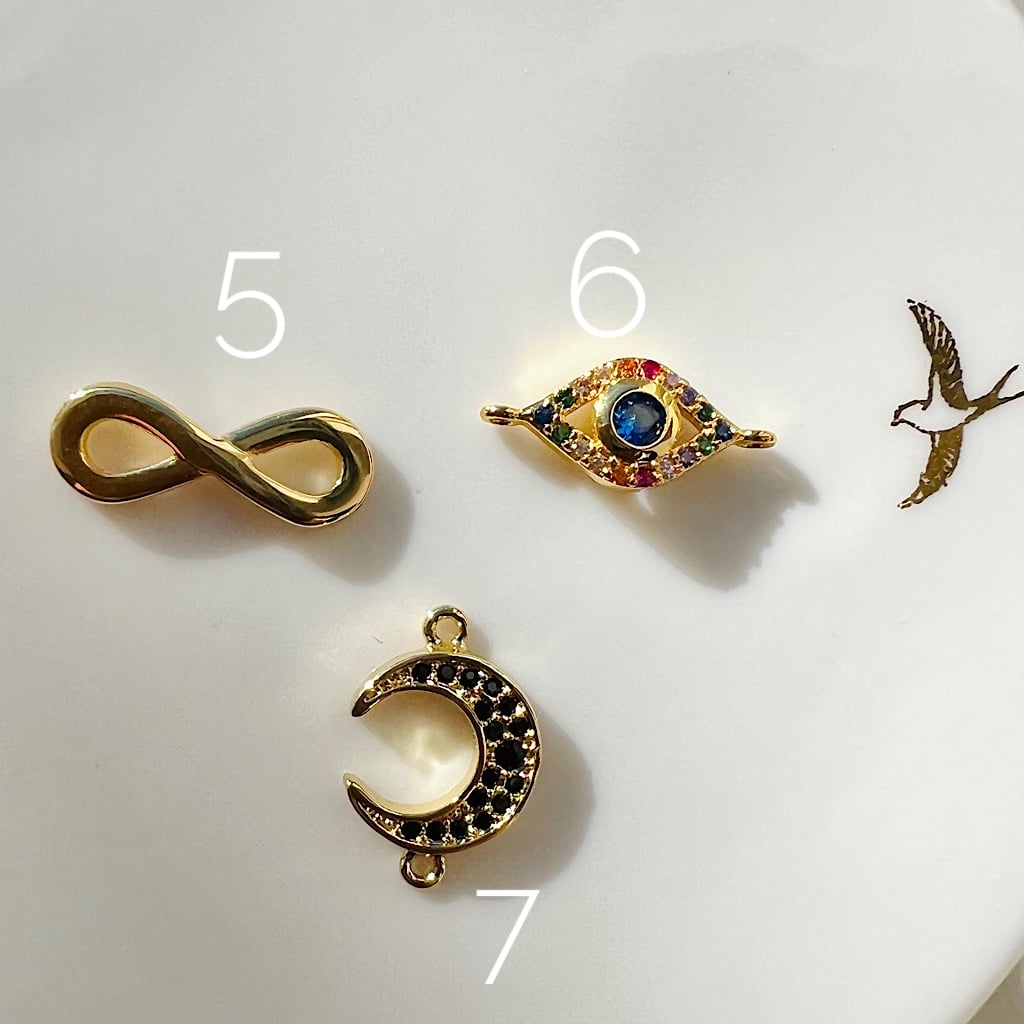 Petits connecteurs infini ou oeil plaqués or et zirconium au choix ( à l&
