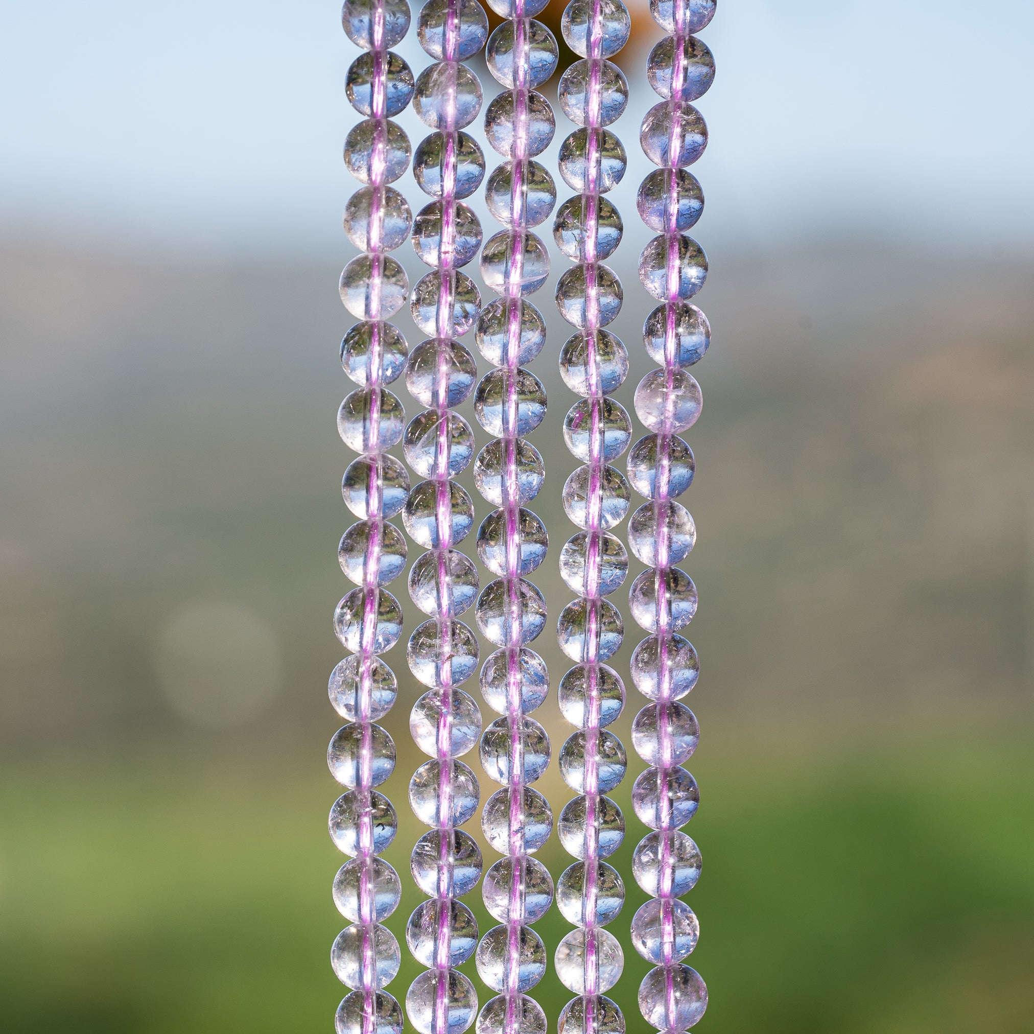 Perles rondes lisses en Améthyste lilas grade A de 6,5 mm ( 1/2 rang de env 30 perles )