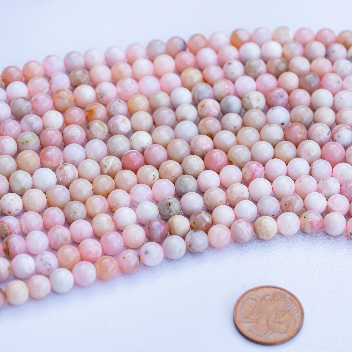 Perles rondes lisses en Opale rose grade a de 6/6,5 mm ( 1/2 rang de env 33/30 perles )