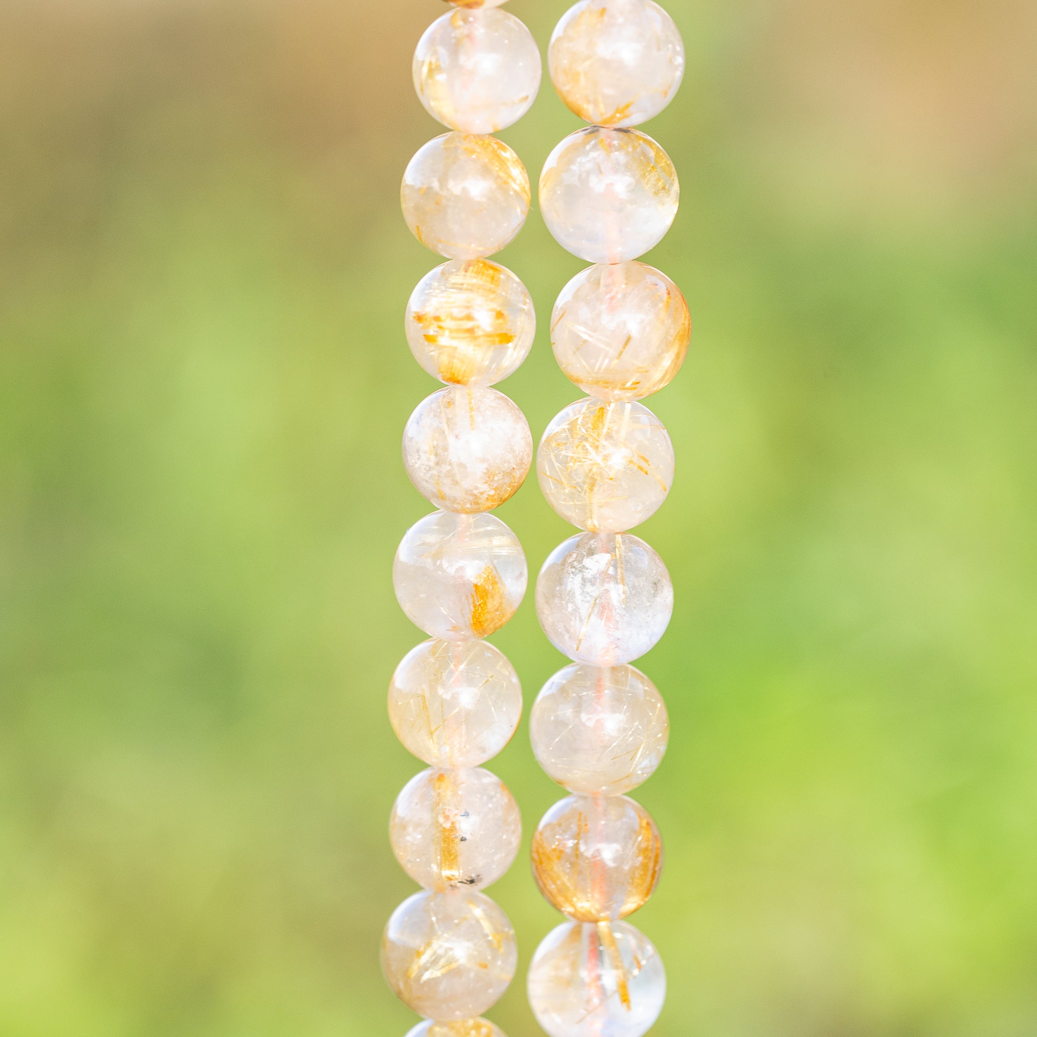 Perles rondes lisses de Quartz Rutile doré de 8,7 mm ( 1/4 de rang de env 11 perles )