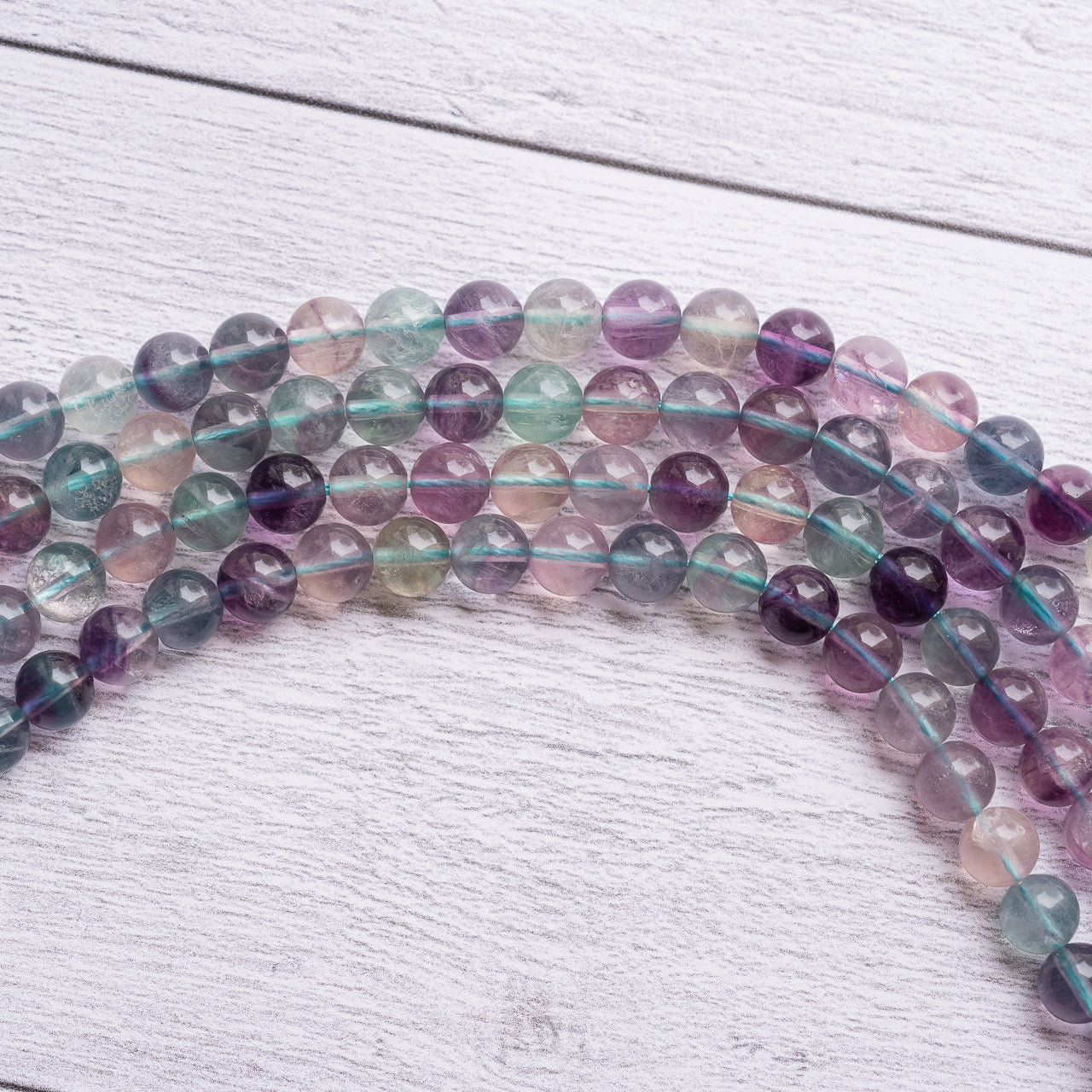 Perles rondes lisses de Fluorite multicolore de 7/8 mm ( rang de env 50/52 perles )