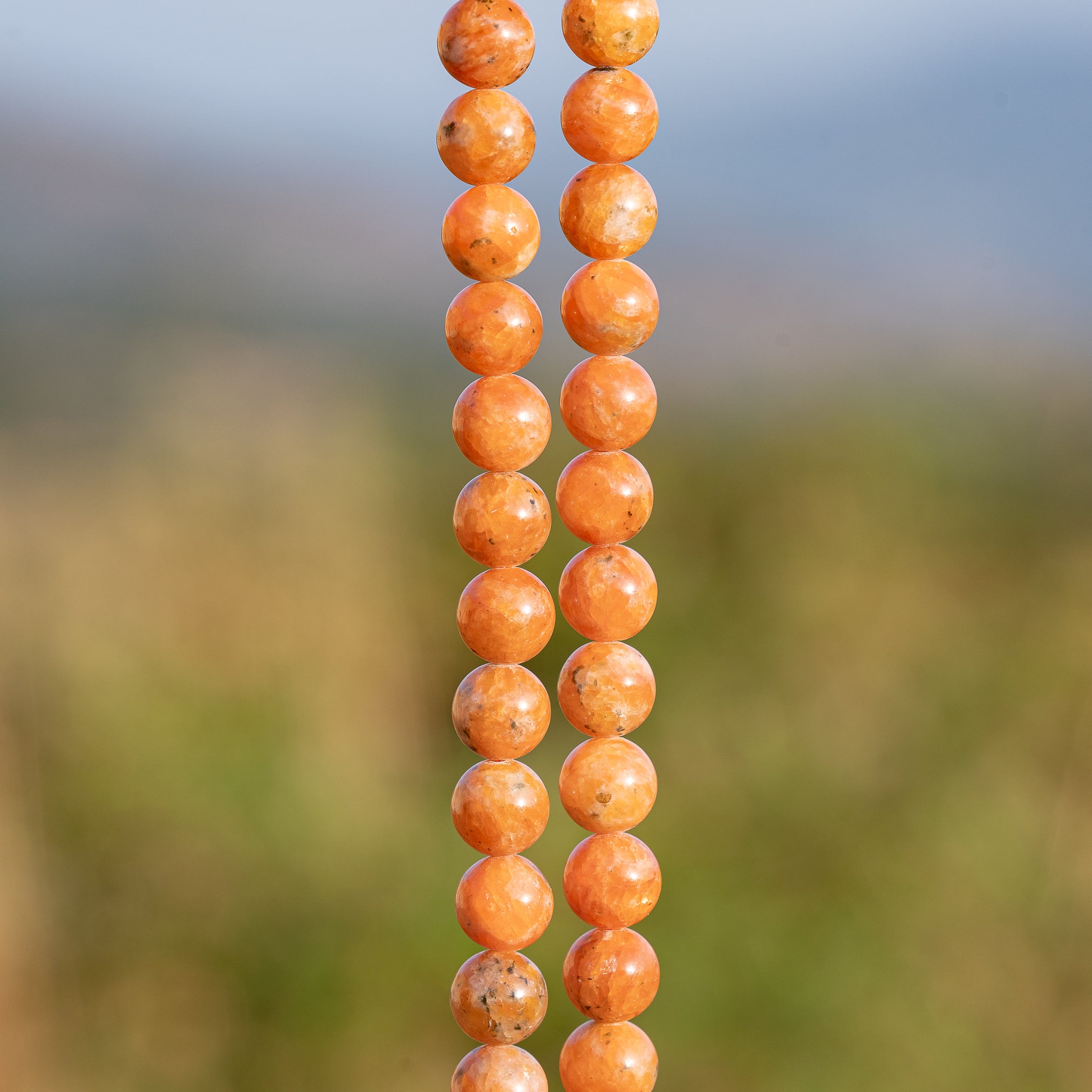 Perles rondes lisses de Calcite orange de 8,3 mm ( 1/2 rang de env 24 perles )