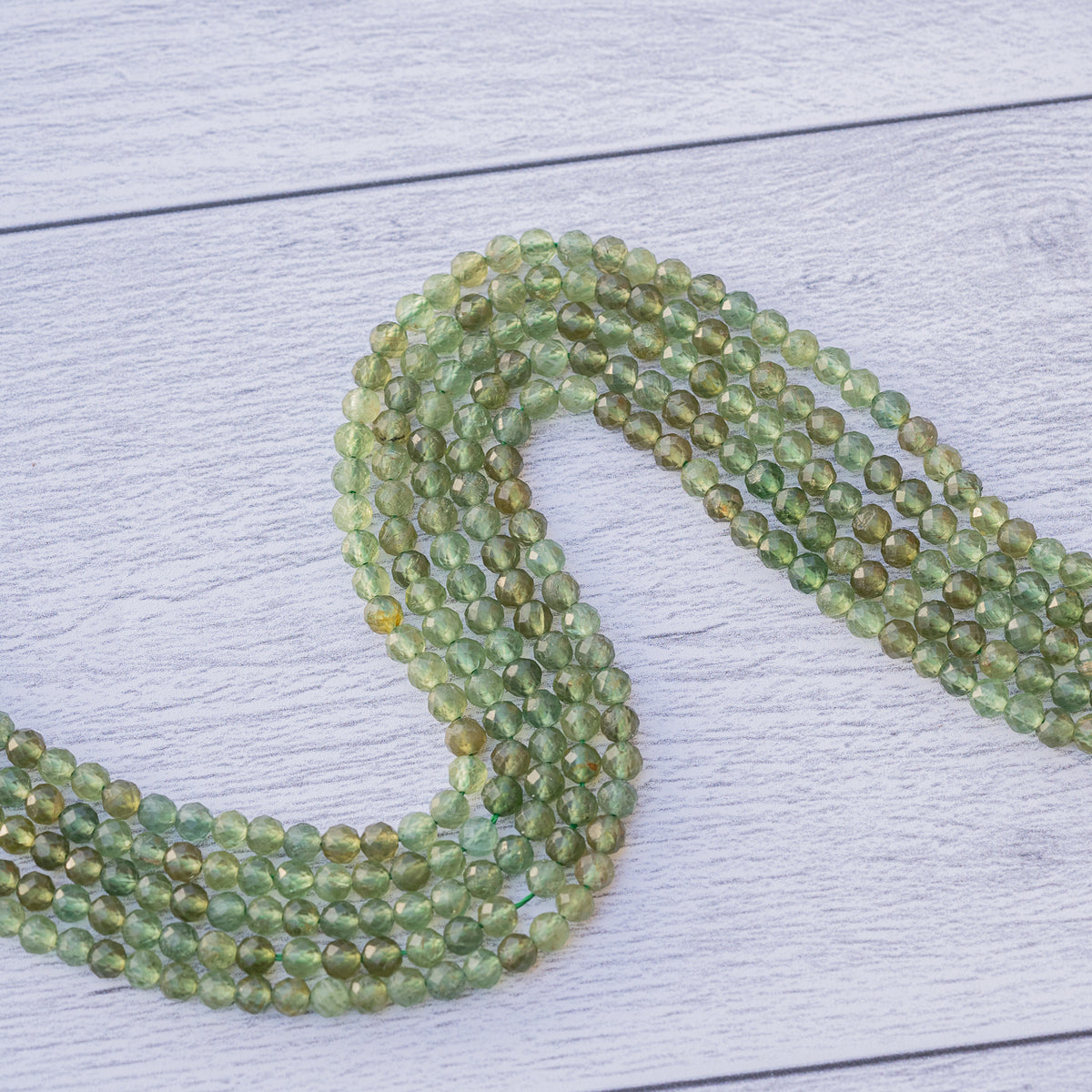 Perles rondes facettes en Apatite verte de 4 mm ( rang de env 98 perles )