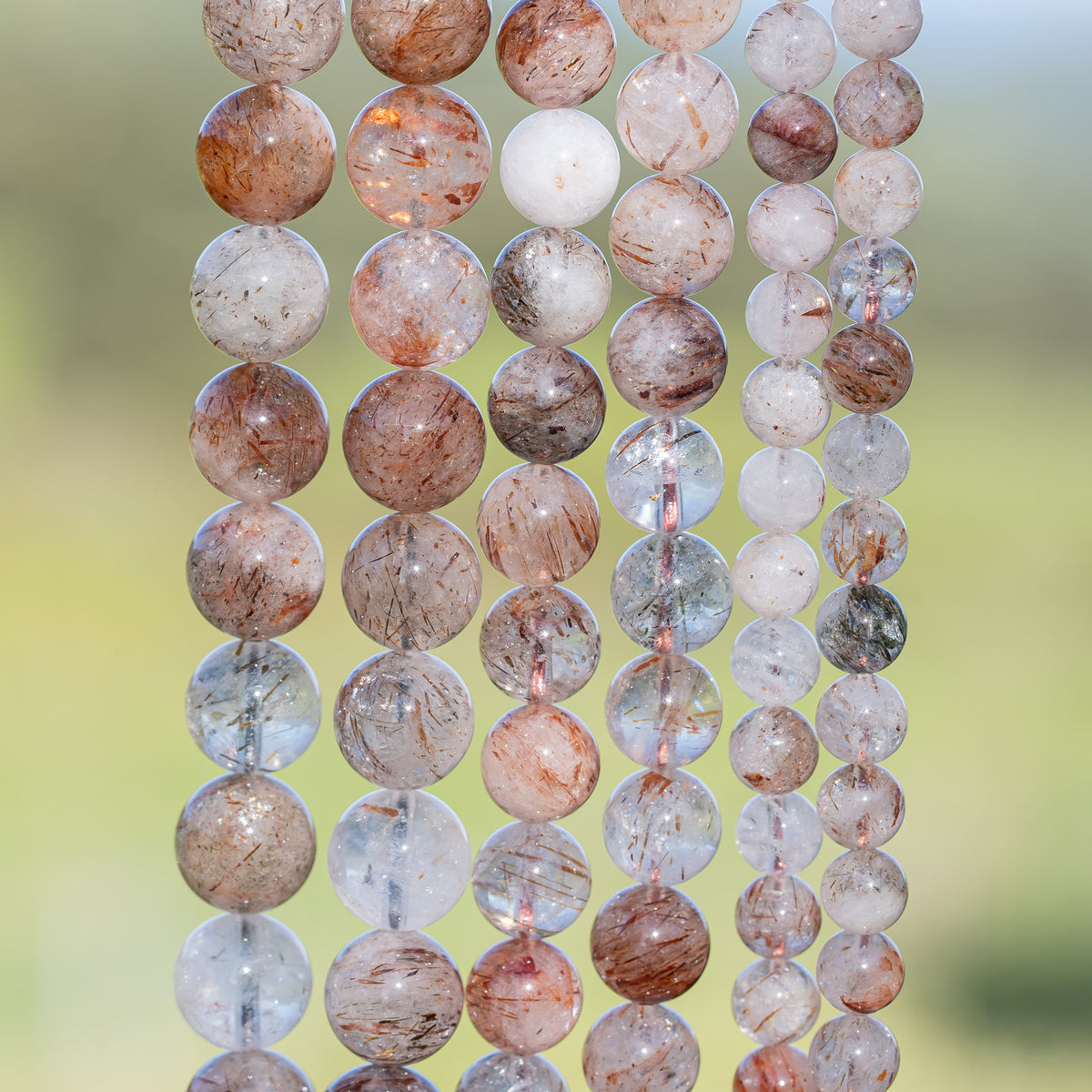 Perles rondes lisses de Quartz à inclusions de Rutile rouge de 10 mm ( 1/2 rang )