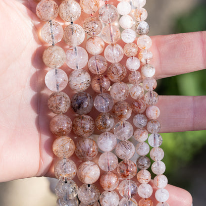 Perles rondes lisses de Quartz à inclusions de Rutile rouge de 10 mm ( 1/2 rang )