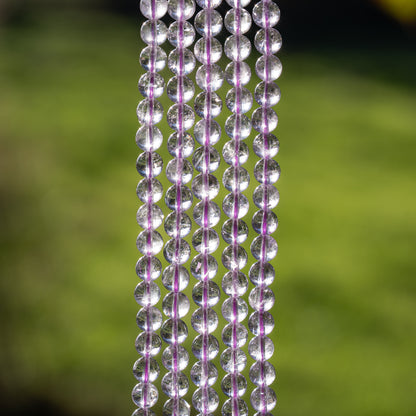 Perles rondes lisses en Améthyste lilas grade A de 6,5 mm ( 1/2 rang de env 29/30 perles )