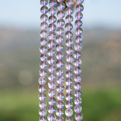Perles rondes lisses en Améthyste lilas grade A de 6,5 mm ( 1/2 rang de env 29/30 perles )