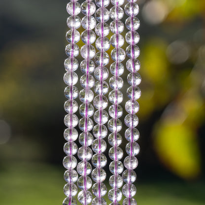 Perles rondes lisses en Améthyste lilas grade A de 6,5 mm ( 1/2 rang de env 29/30 perles )