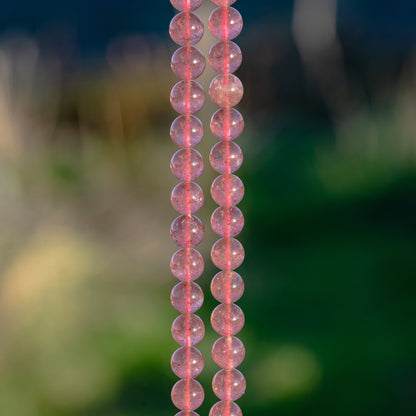 Perles rondes lisses de Quartz fraise de 8,5 mm ( 1/2 rang de env 23 perles )
