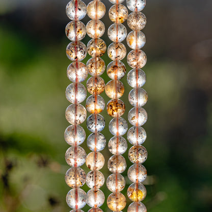 Perles rondes lisses de Quartz à inclusions de 8/8,5 mm ( 1/2 rang de env 22/24 perles )