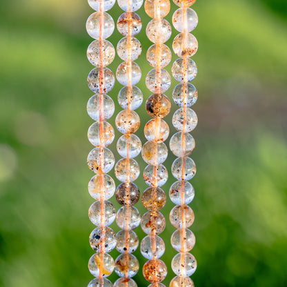 Perles rondes lisses de Quartz à inclusions de 8/8,5 mm ( 1/2 rang de env 22/24 perles )