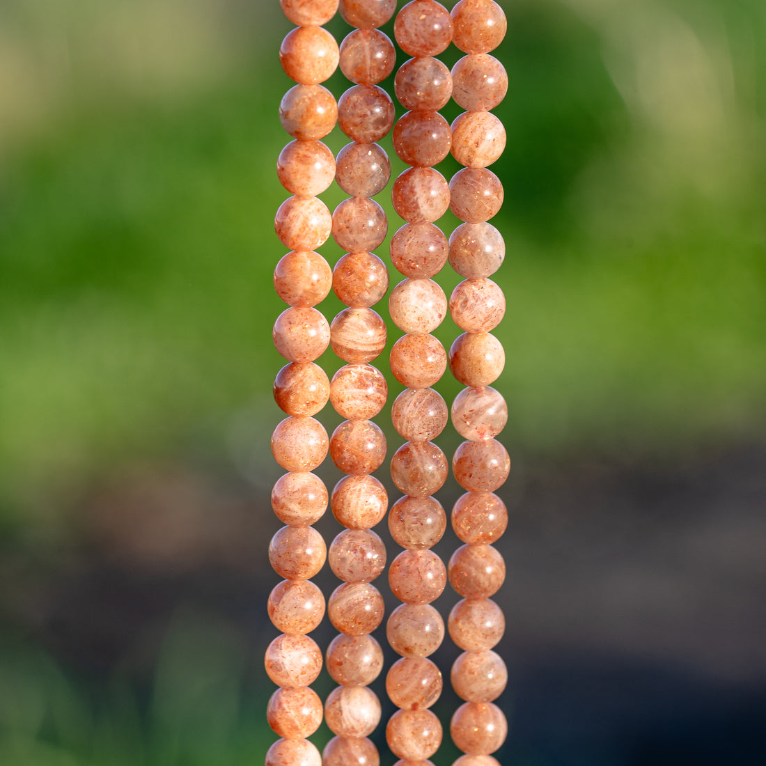 Perles rondes lisses de Pierre de Soleil de 6 mm ( rang de env 62 perles )