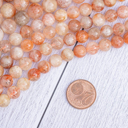 Perles rondes lisses de Pierre de soleil de 8 ou 10 mm ( 1/2 rang de env 24 perles ou 20 perles )