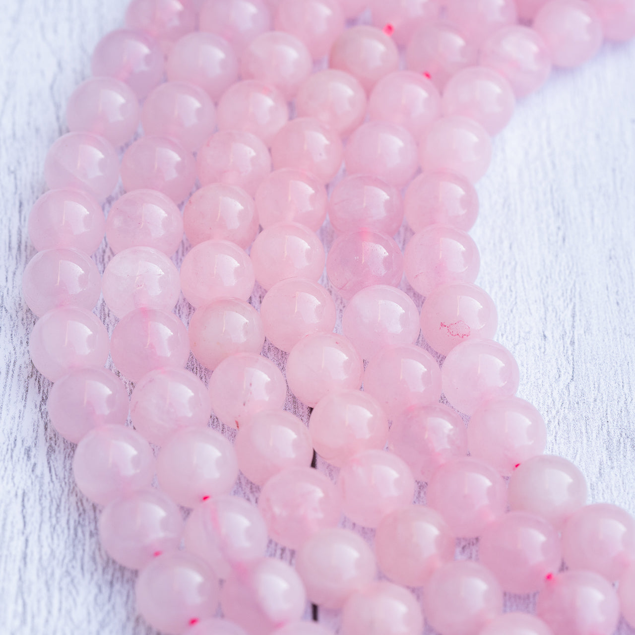 Perles rondes lisses de Quartz rose de 12 mm ( 1/2 rang de env 16 perles )