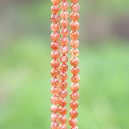 Perles rondes lisses de Pierre de soleil extra de 7 mm ( lot de 6 perles ou 1/2 rang )