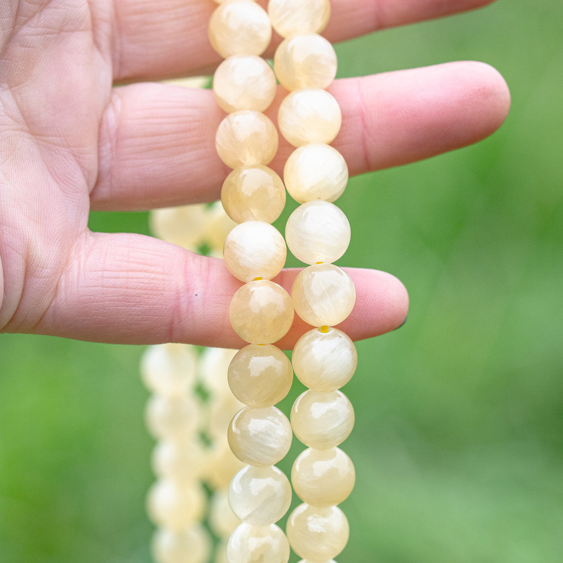 Perles rondes lisses de Calcite miel de 10 mm ( lot de 10 perles )