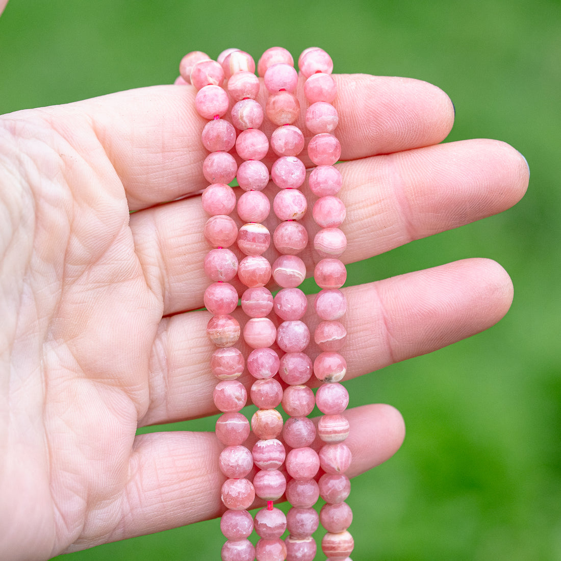 Perles rondes lisses de Rhodochrosite de 6 mm ( 1/2 rang de env 33/35 perles )