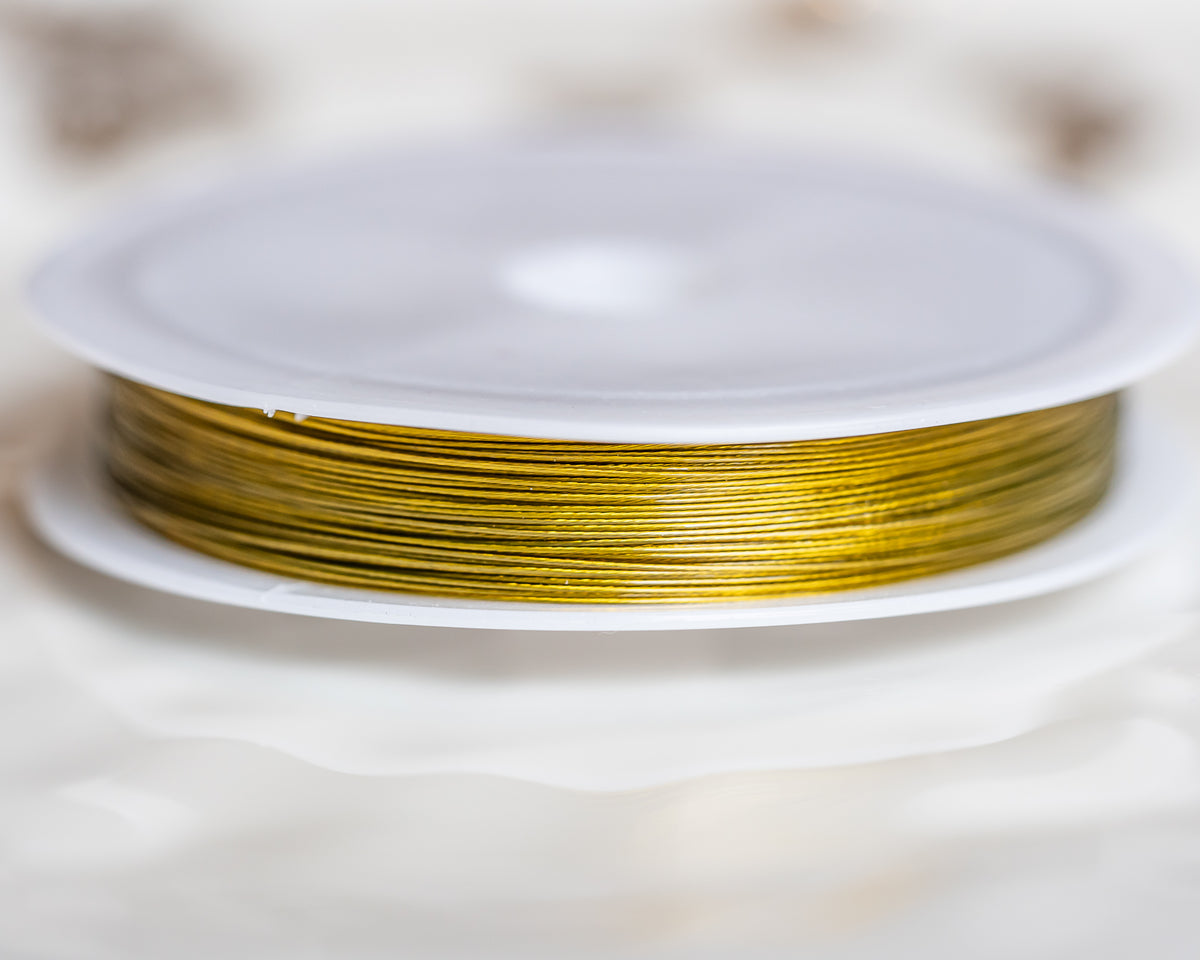 Fil câblé en acier inoxydable doré de 0,45 mm ( bobine de 50 mètres )
