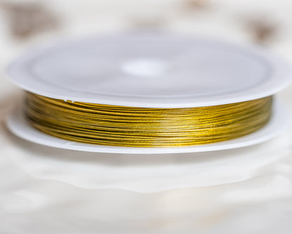 Fil câblé en acier inoxydable doré de 0,45 mm ( bobine de 50 mètres )