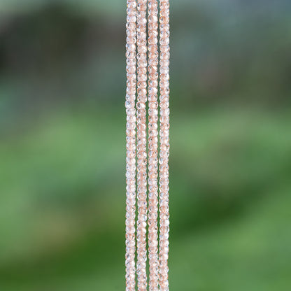 Perles rondelles facettes de zirconium pêche de 3 x 2 mm ( 1/2 rang de env 80 perles )