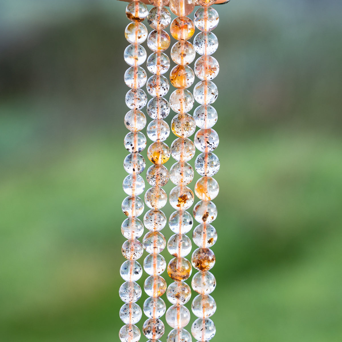 Perles rondes lisses de Quartz à inclusions de 6/7 mm ( par 1/2 rang )