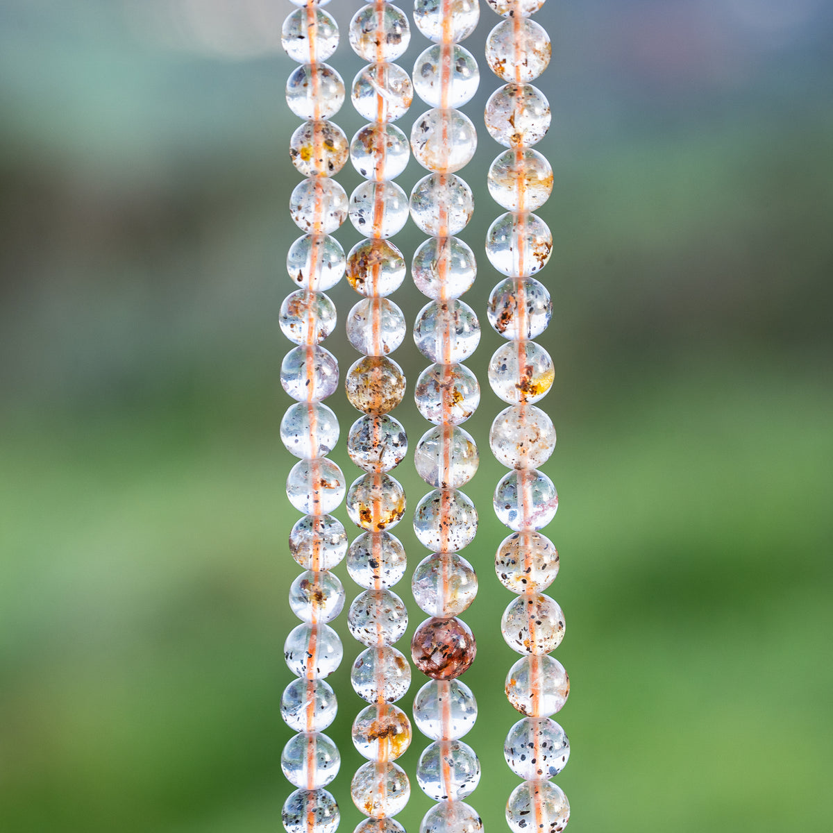 Perles rondes lisses de Quartz à inclusions de 6/7 mm ( par 1/2 rang )