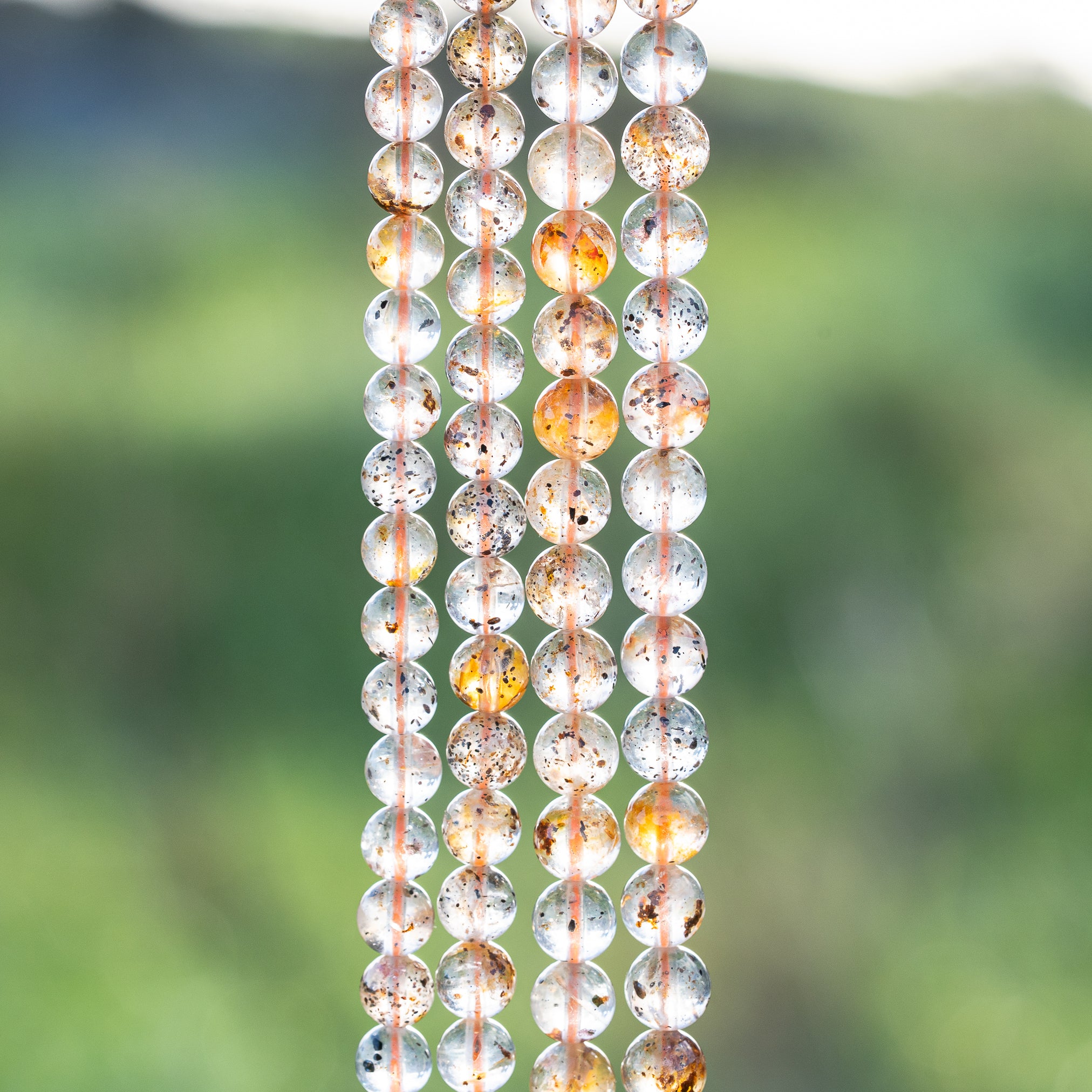 Perles rondes lisses de Quartz à inclusions de 6/7 mm ( par 1/2 rang )