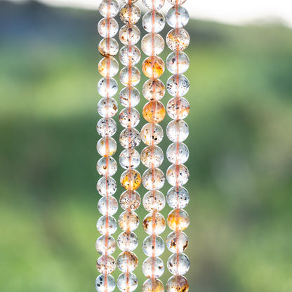 Perles rondes lisses de Quartz à inclusions de 6/7 mm ( par 1/2 rang )