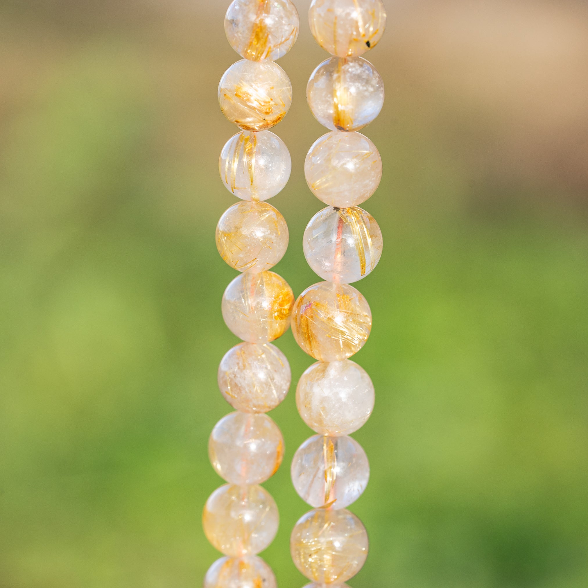 Perles rondes lisses de Quartz Rutile doré de 8,7 mm ( 1/4 de rang de env 11 perles )