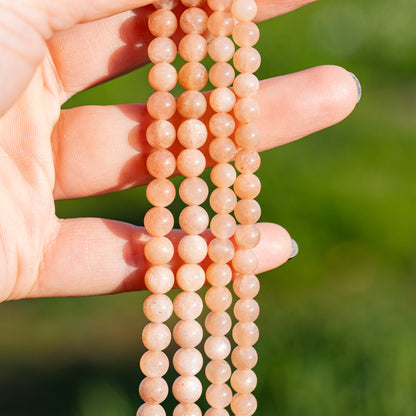 Perles rondes lisses de Pierre de soleil de 6 mm ( par 1/2 rang )