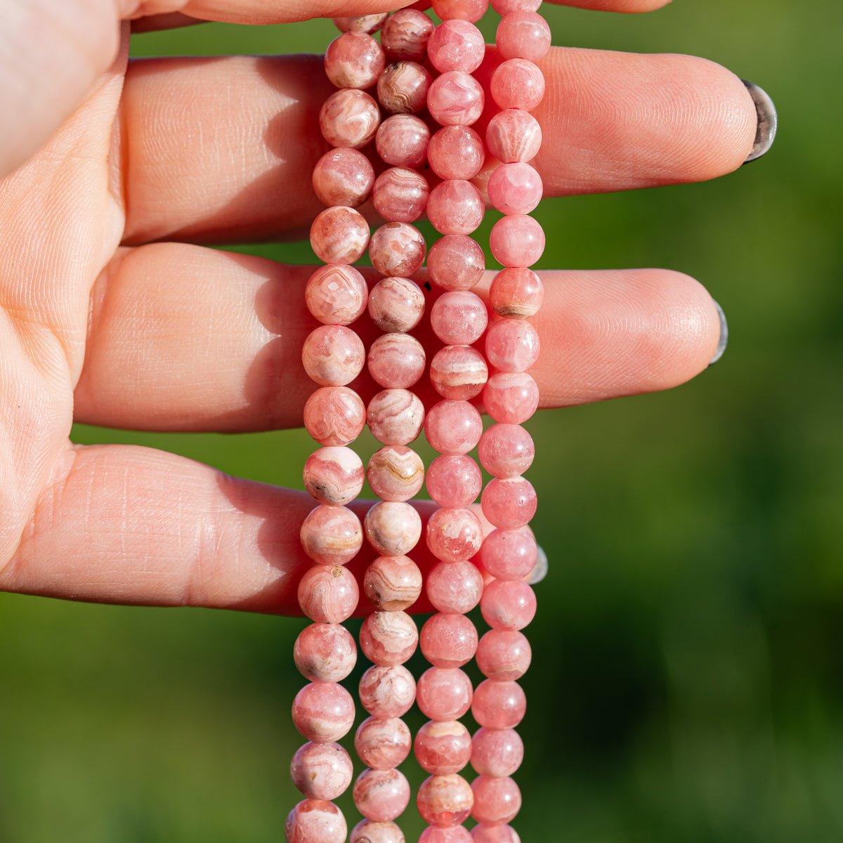 Perles rondes lisses de Rhodochrosite de 6/7 mm ( par 1/2 rang )