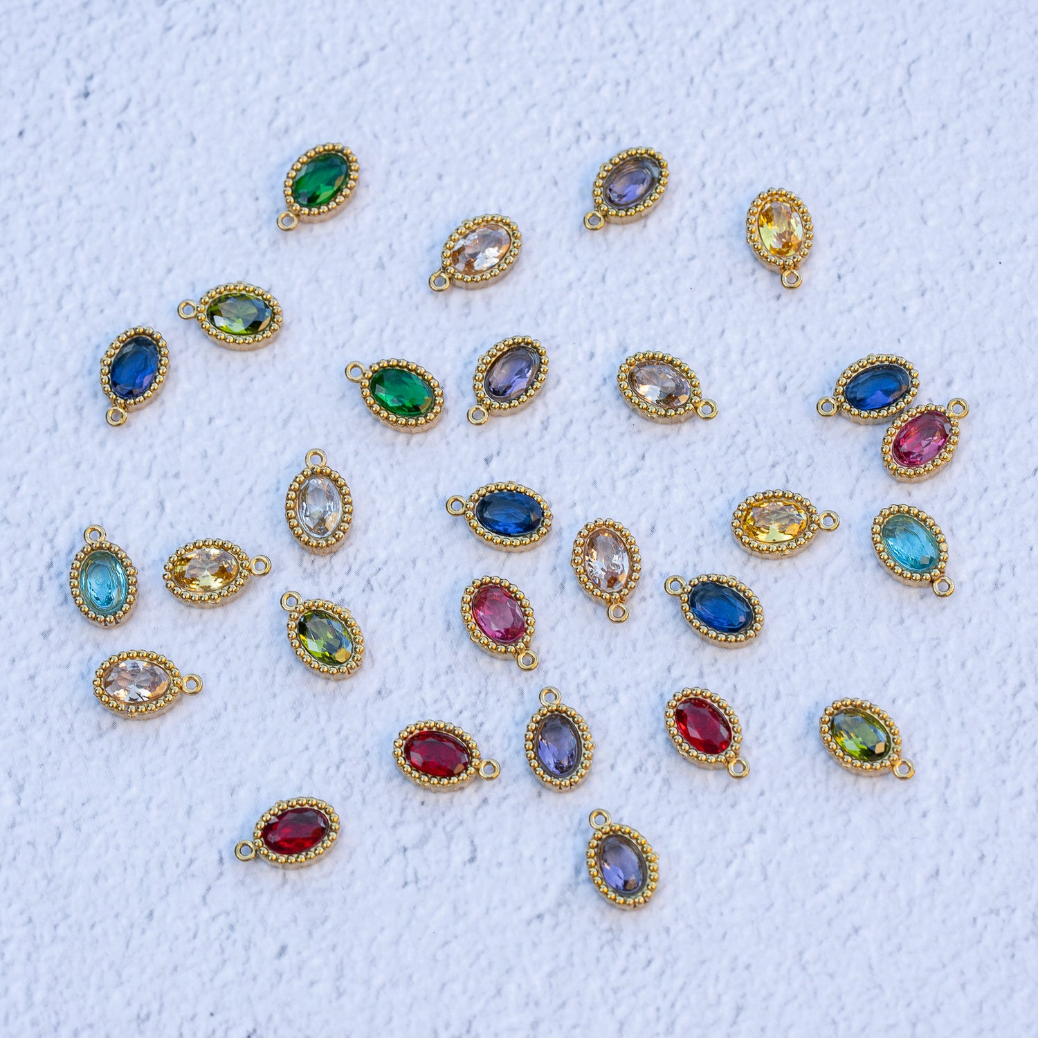 Breloques ovales en acier inox plaqué or 18k et zirconium colorés au choix de 10,5 mm ( à l&