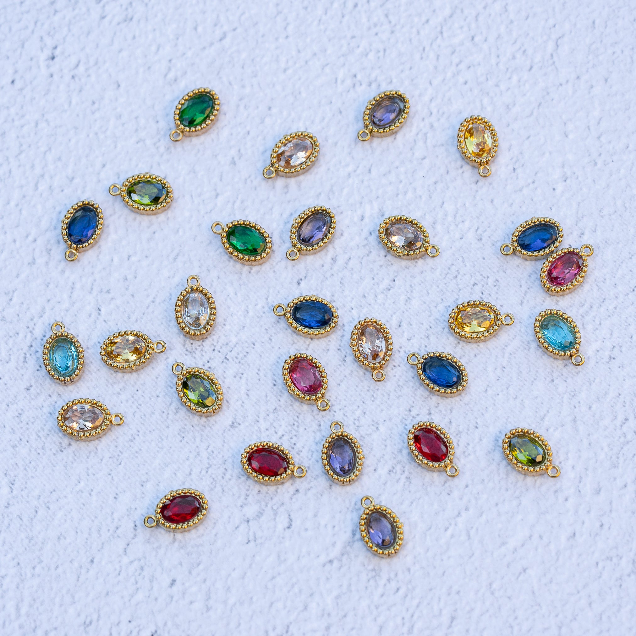 Breloques ovales en acier inox plaqué or 18k et zirconium colorés au choix de 10,5 mm ( à l&