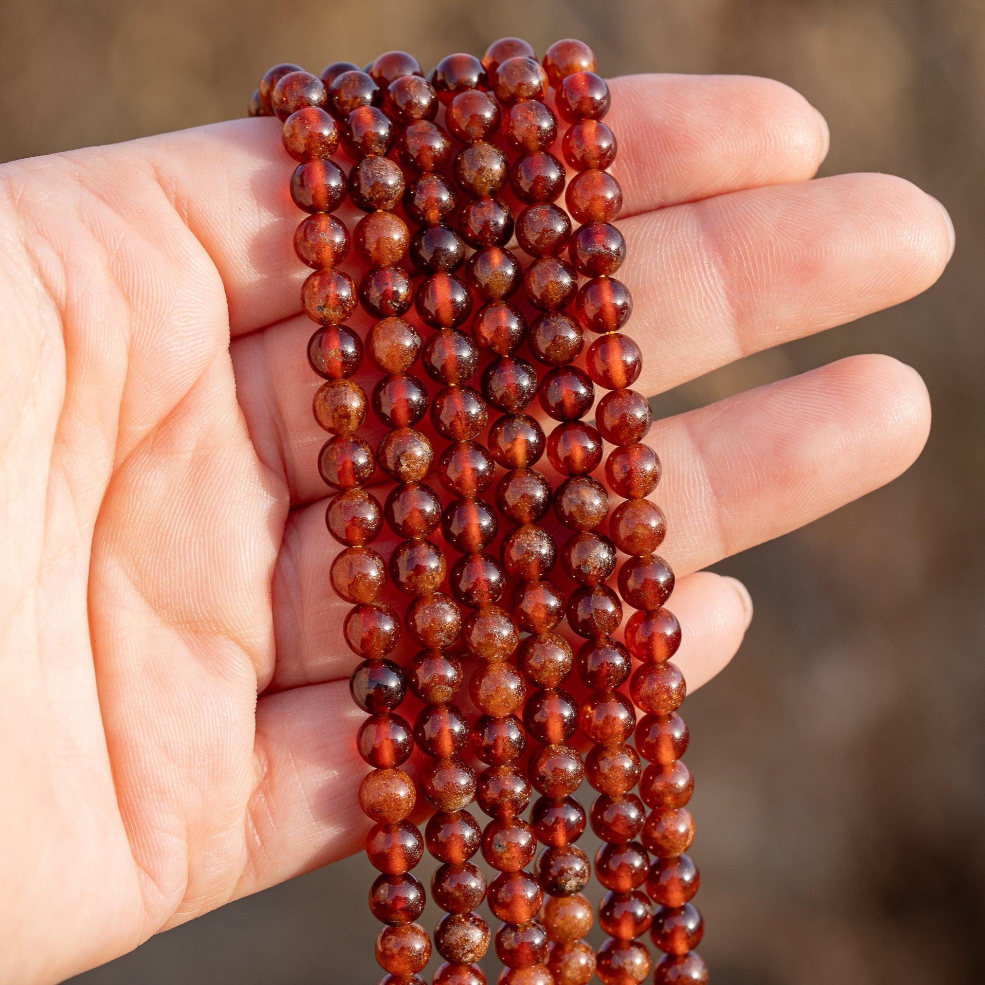 Perles rondes lisses de Grenat orange de 5,8 mm ( 1/2 rang de env 34 perles )