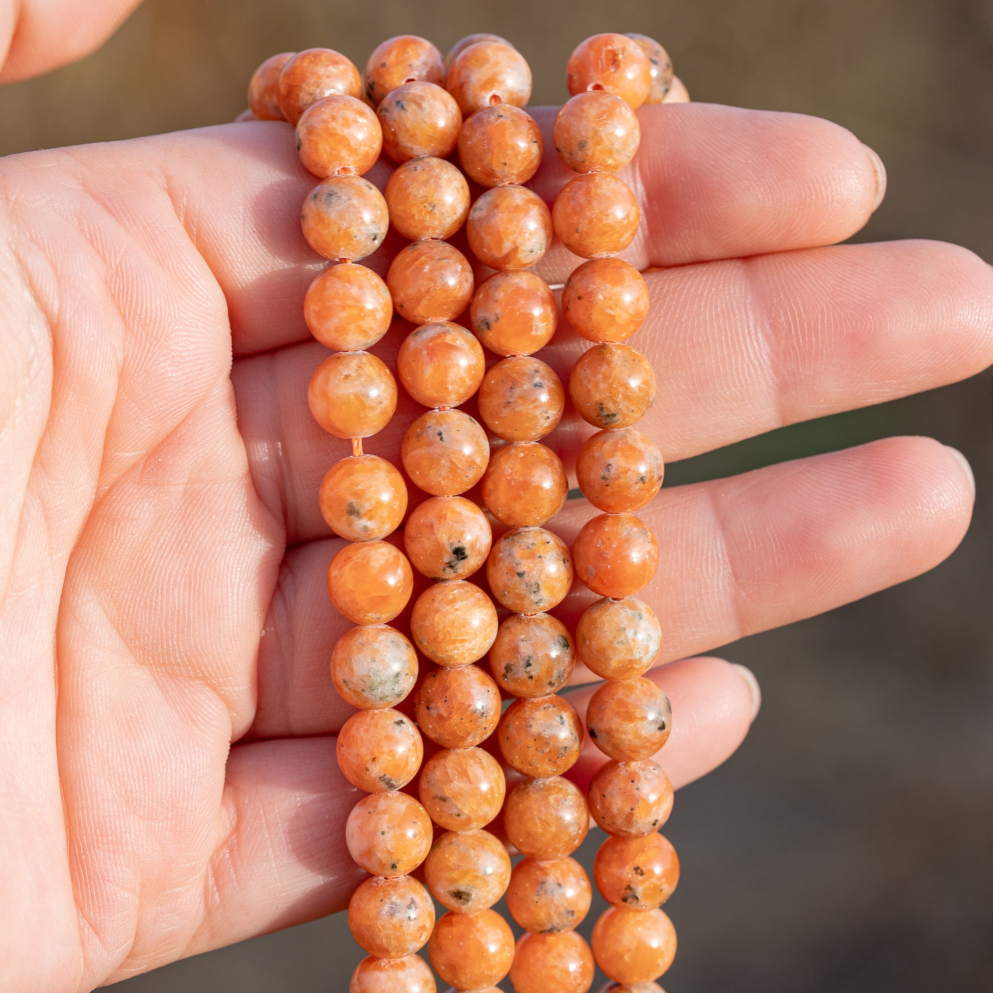 Perles rondes lisses de Calcite orange de 8,3 mm ( 1/2 rang de env 24 perles )