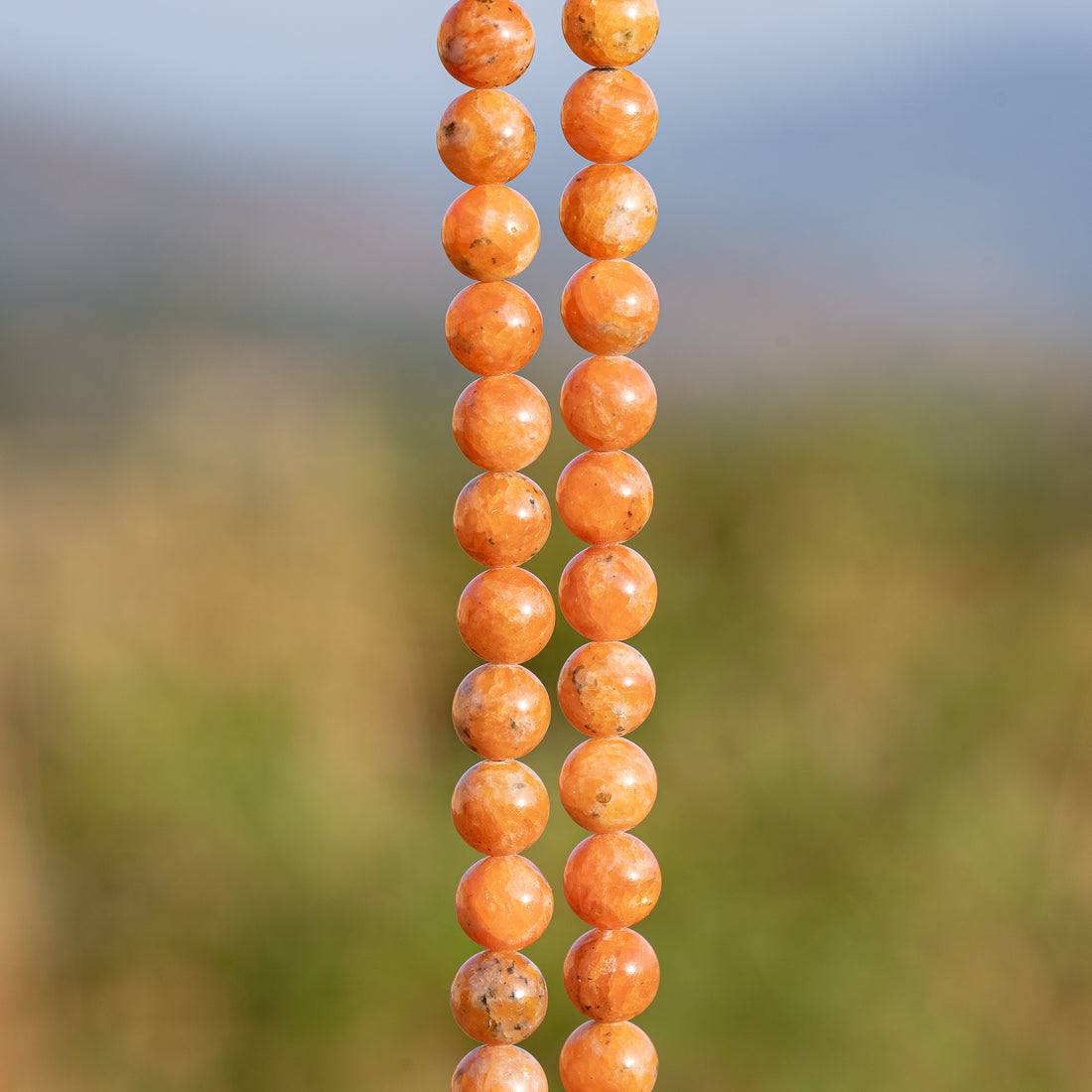 Perles rondes lisses de Calcite orange de 8,3 mm ( 1/2 rang de env 24 perles )