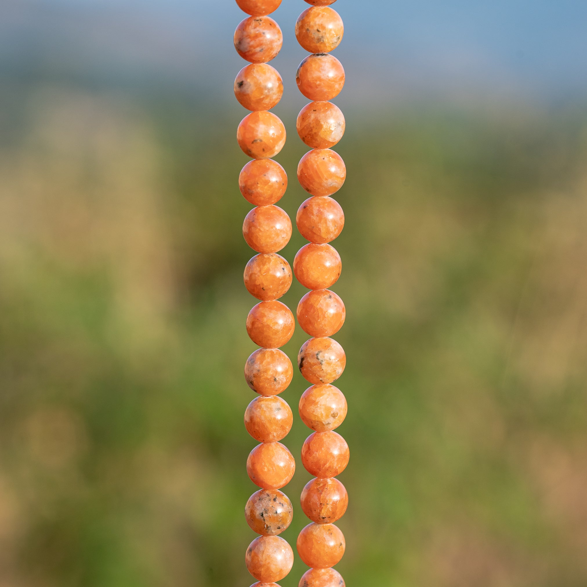 Perles rondes lisses de Calcite orange de 8,3 mm ( 1/2 rang de env 24 perles )