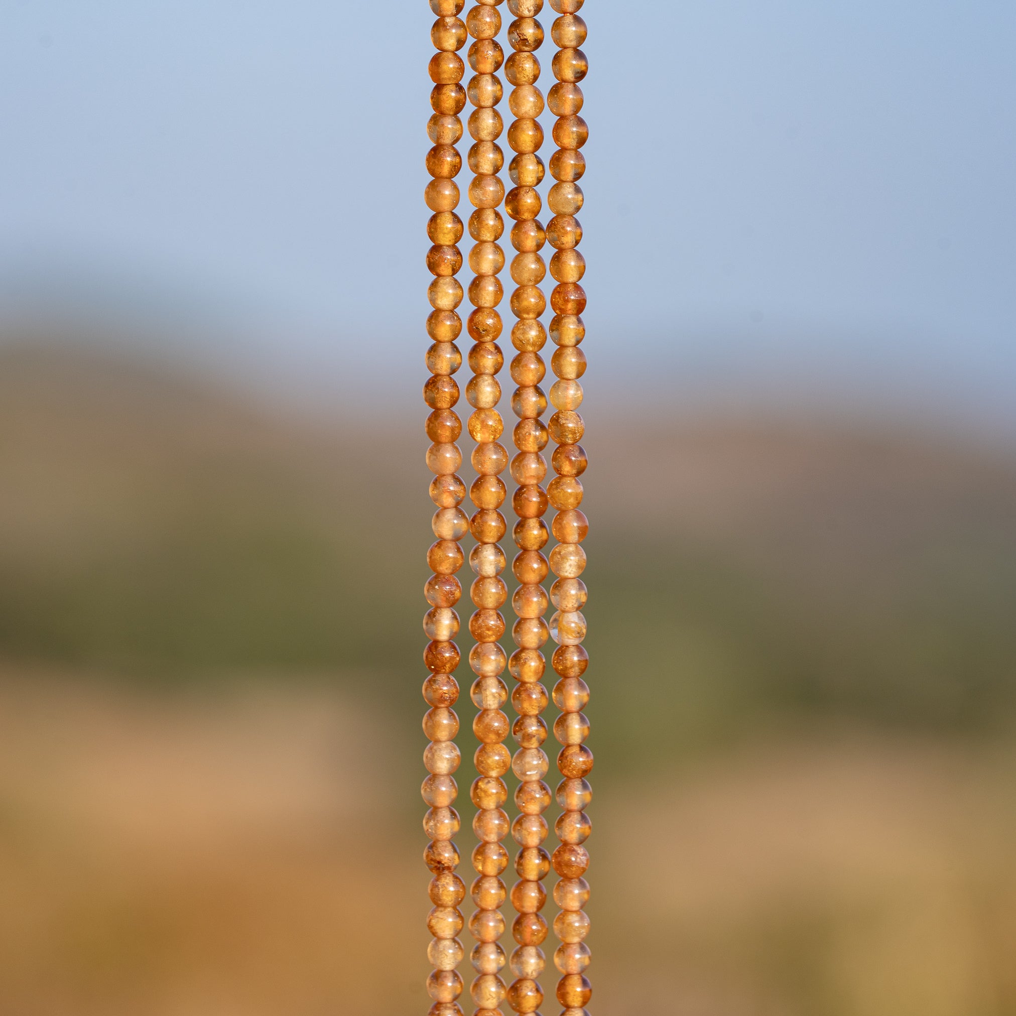 Perles rondes lisses de Grenat orange de 3 mm ( rang de env 144 perles )