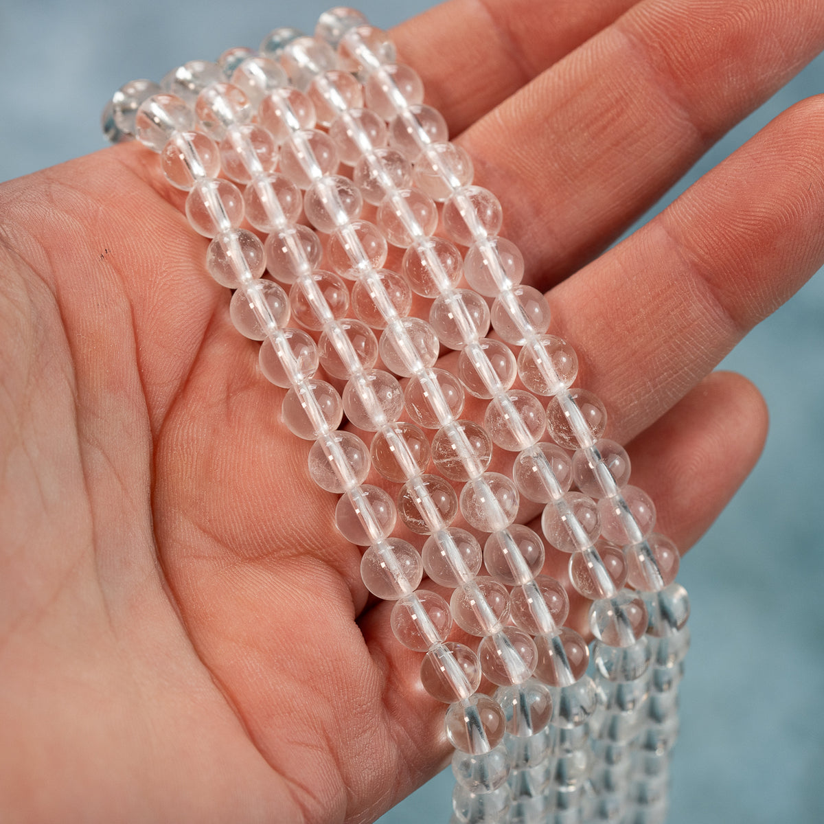 Perles rondes lisses de cristal de roche de 6 mm ( rang de env 66 perles )
