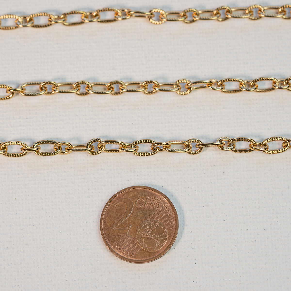 Chaine ovale texturée en acier inoxydable plaqué or 18k de 5/7 mm ( par 50 cm )