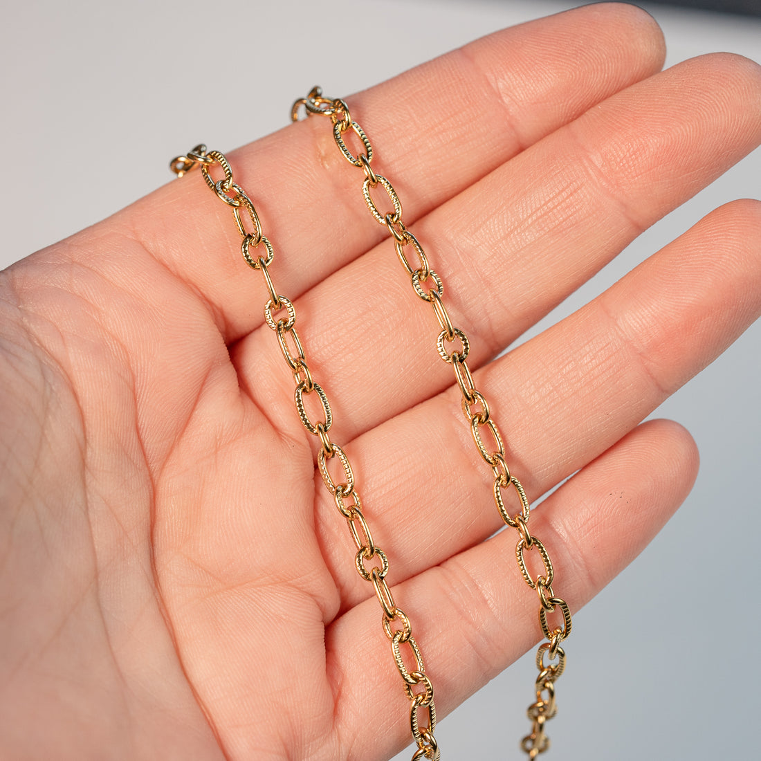 Chaine ovale texturée en acier inoxydable plaqué or 18k de 5/7 mm ( par 50 cm )