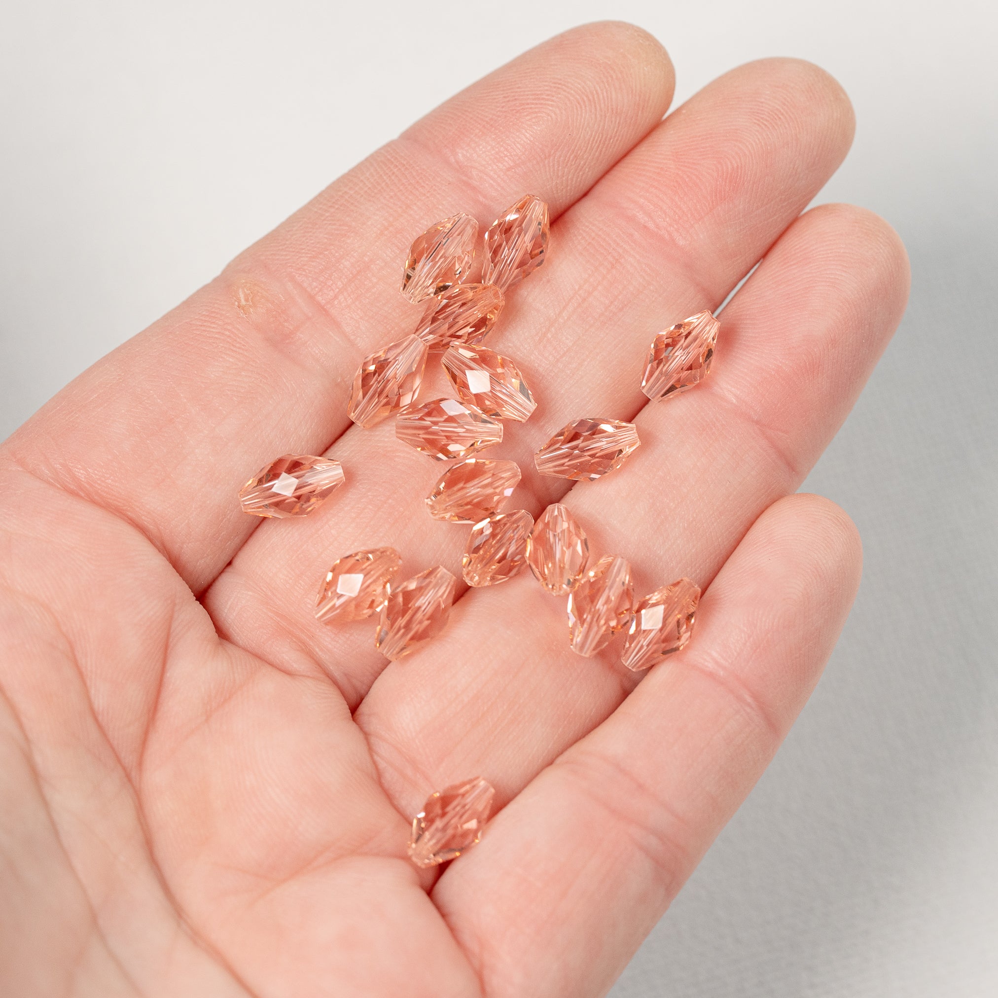 Perles ovales facettes en verre K9 rose saumon de 9,5 x 5,5 mm ( lot de 2 )